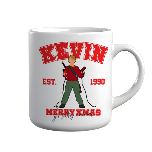 [kintu:17vWoSTPpr6RjZBaPpOYZkus8l5i7zVT7:fa9172176b175c9dab40ddb836632534] Tazza bianca Kevin Merry Xmas con illustrazione cartoon e grafica natalizia